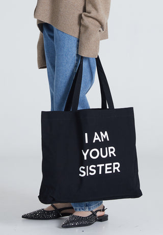 Black Tote Bag with print saying I AM YOUR SISTER
