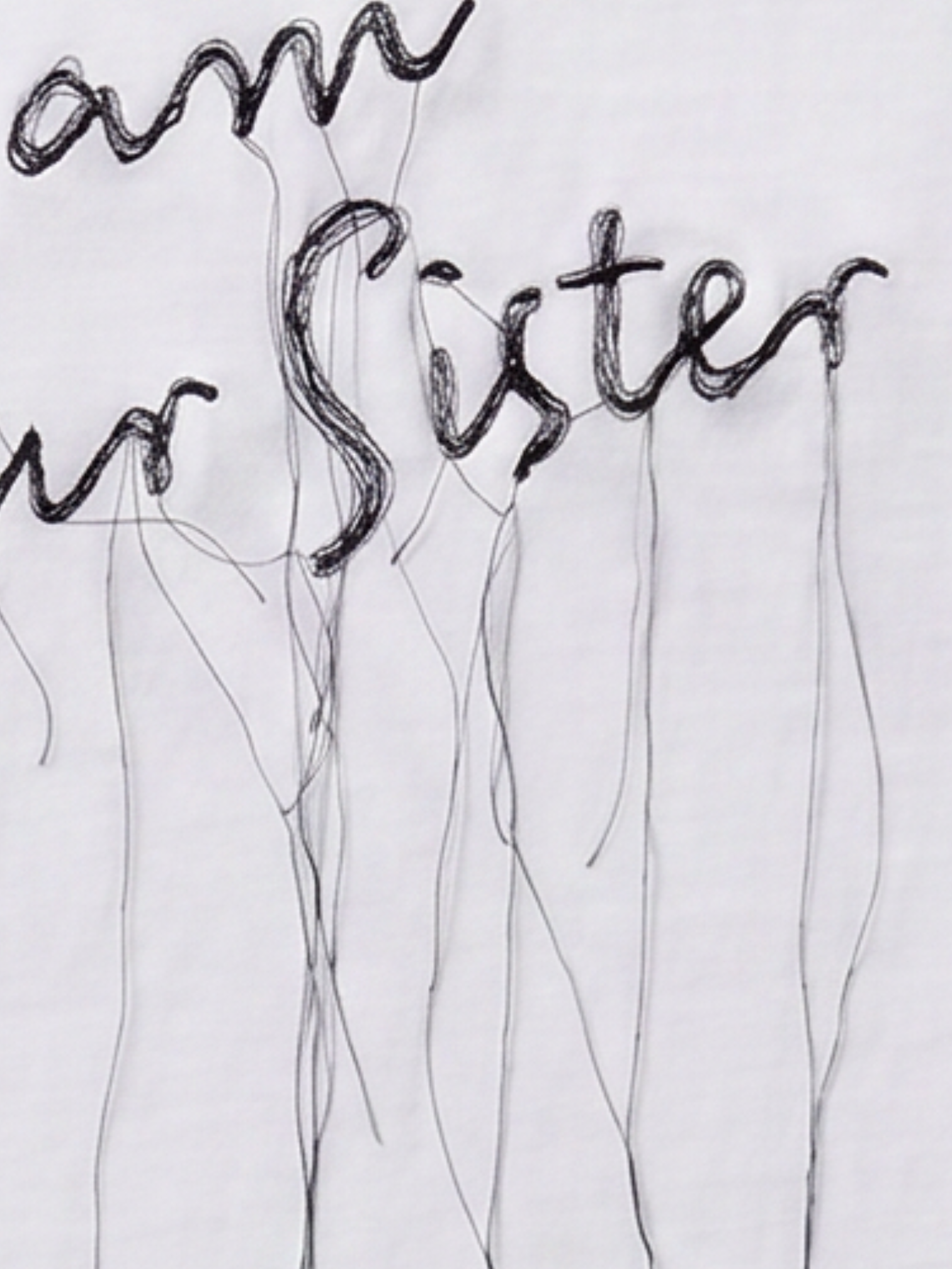 Black embroidered text reading 'I am my sister' with long, dangling thread-like lines on a white background.